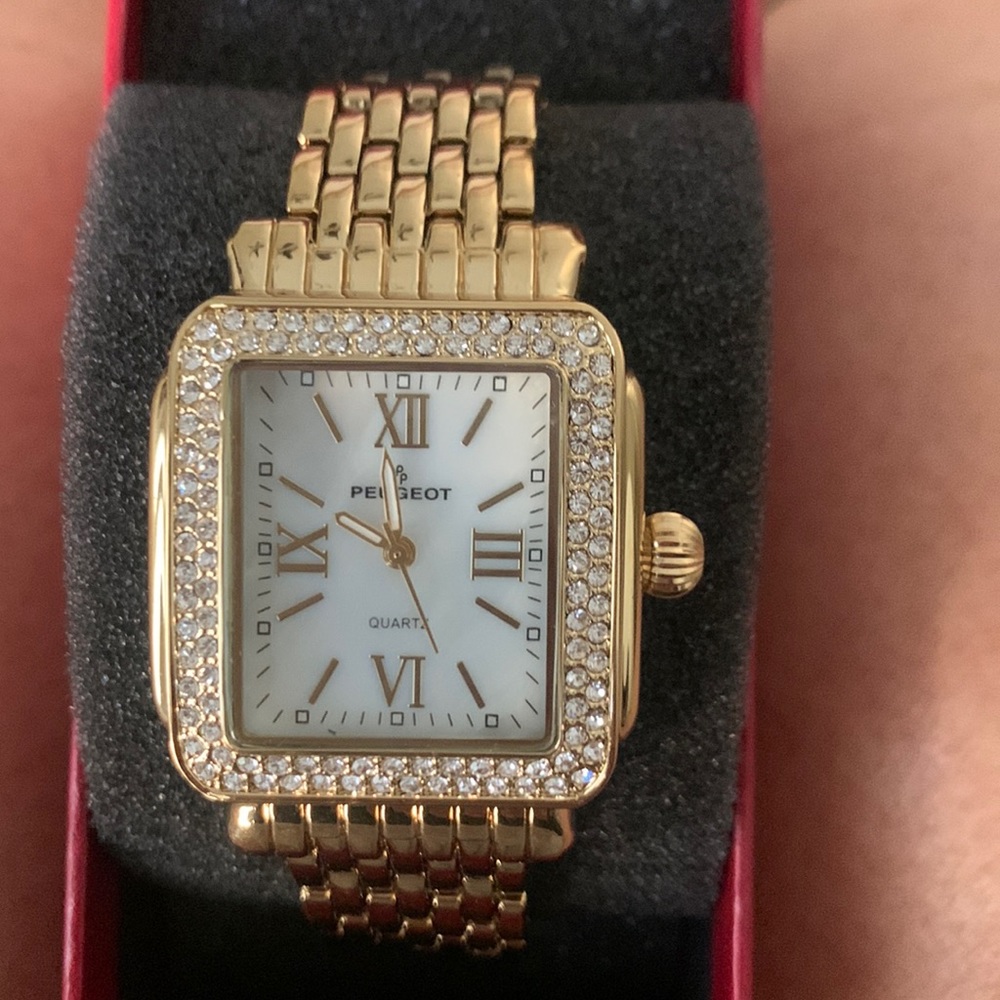 Gold watch with crystal bezel.
